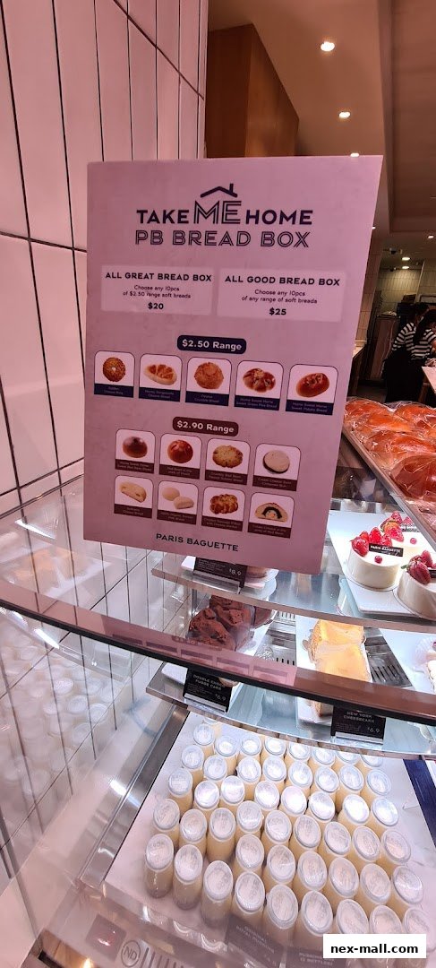 A menu board for Paris Baguette's PB Bread Box with various bread options and prices.