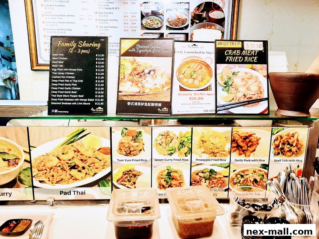A display of Thai food dishes with prices and descriptions, including Pad Thai and Crab Meat Fried Rice.