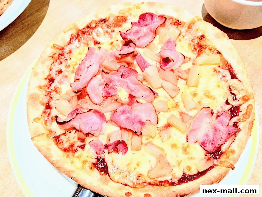 A close-up shot of a delicious pizza topped with ham and pineapple.