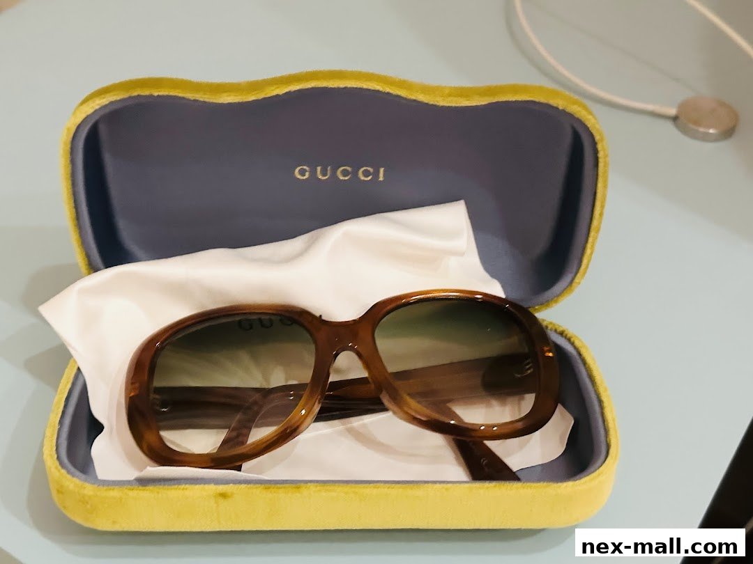 A pair of brown Gucci sunglasses in a yellow velvet case.