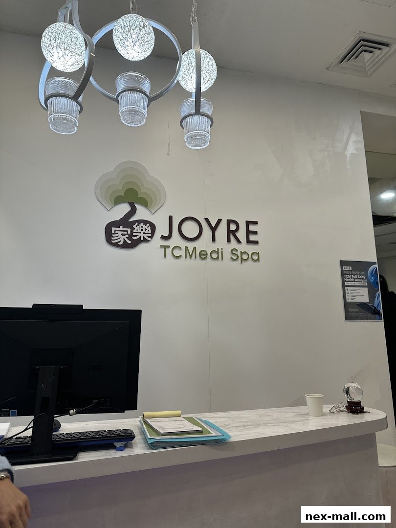 The reception area of Joyre TCMedi Spa with a logo, counter, and computer.