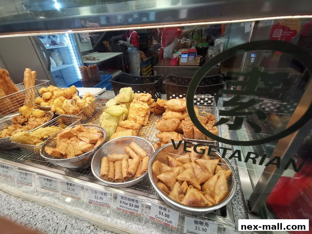 A display of various fried vegetarian snacks, including spring rolls and samosas.