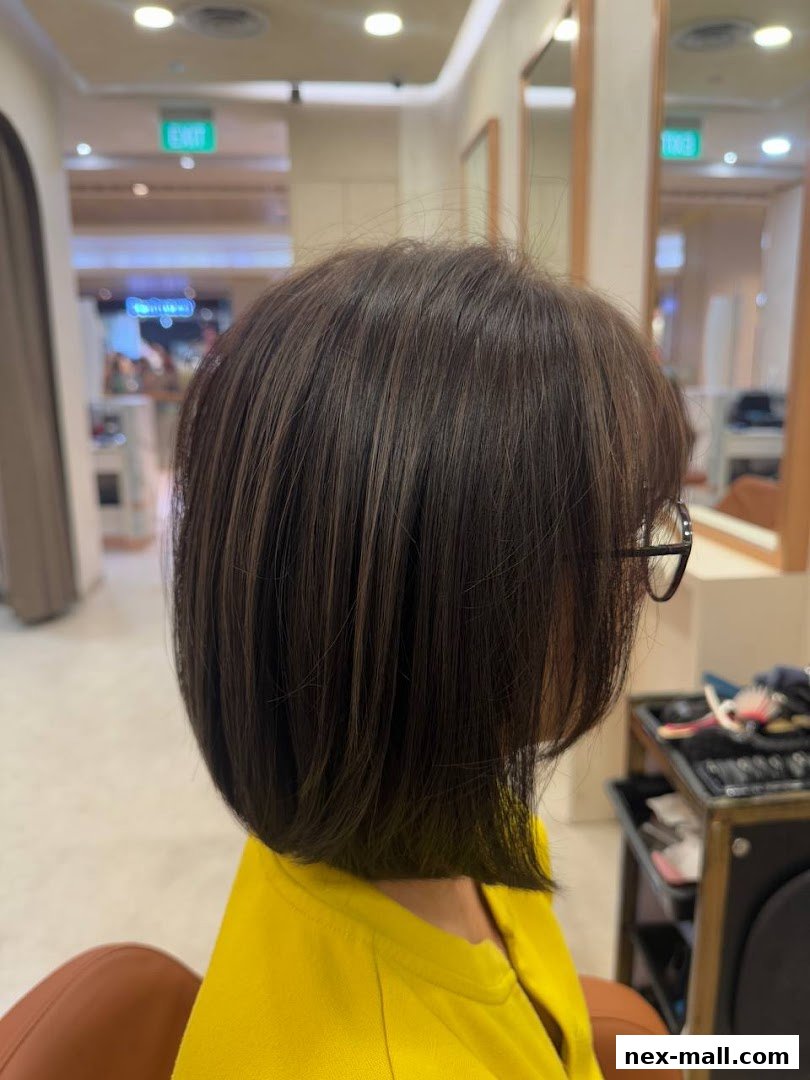 A person with a fresh, stylish bob haircut in a modern salon.