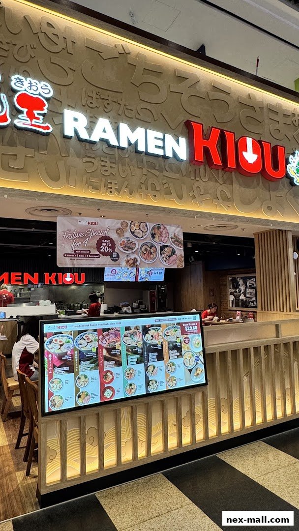 A Ramen Kiou restaurant storefront with a digital menu displaying various ramen dishes.