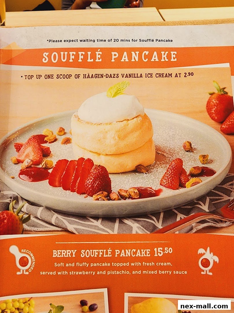 A close-up of a Berry Soufflé Pancake with strawberries and pistachios.