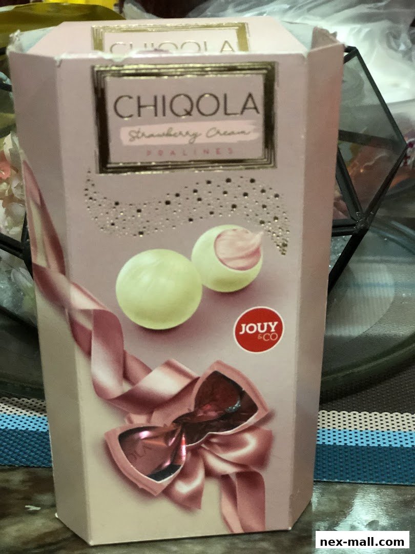 A pink box of CHIQUOLA Strawberry Cream Pralines with a ribbon and bow design.