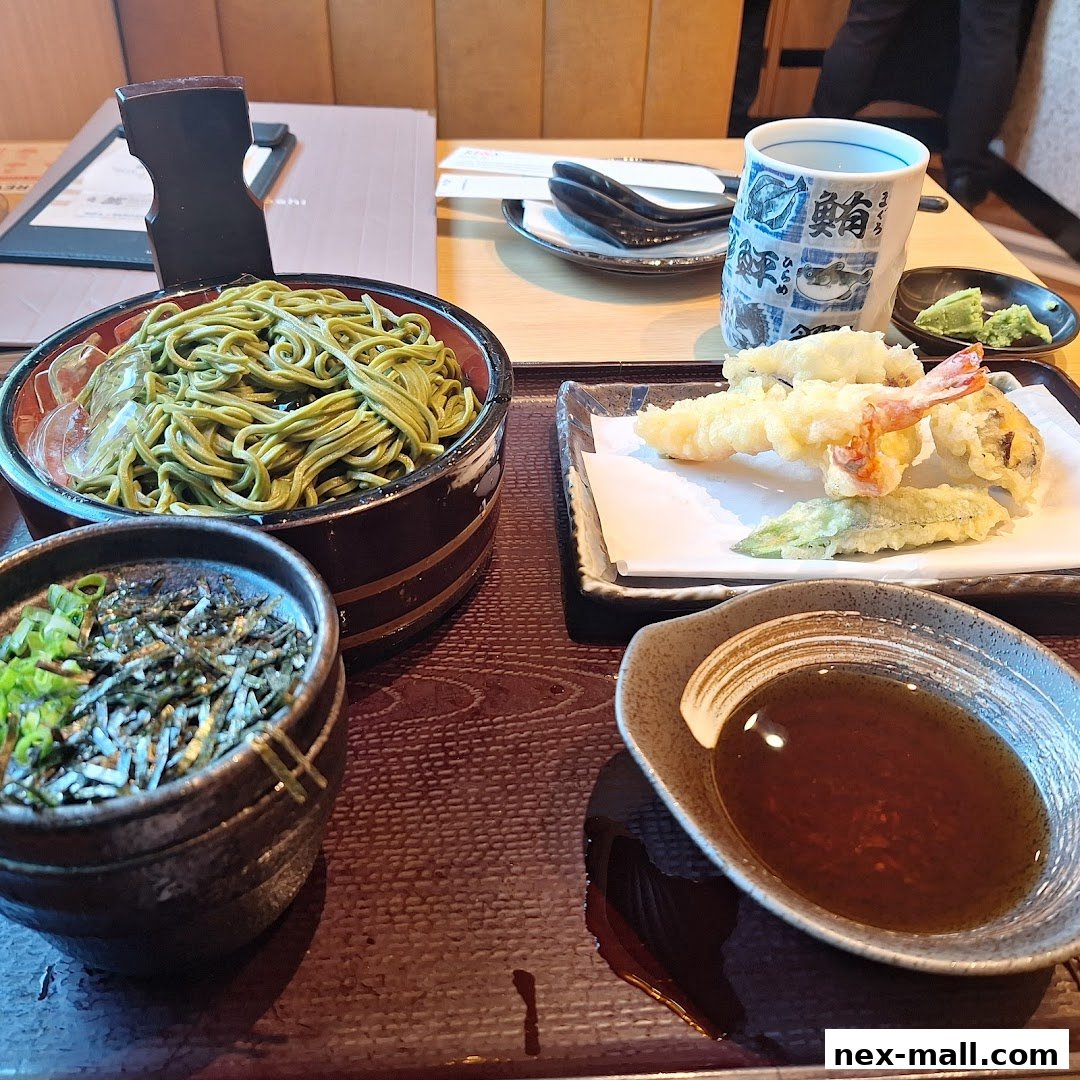A delicious meal of soba noodles with tempura and dipping sauce.