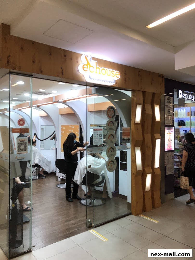 The entrance of EC House All Range Cuts hair salon with stylists attending to customers.