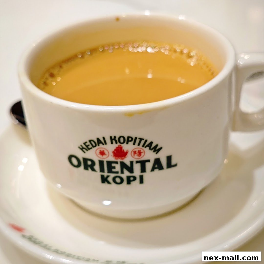 A close-up shot of a steaming cup of Oriental Kopi with the brand logo visible.