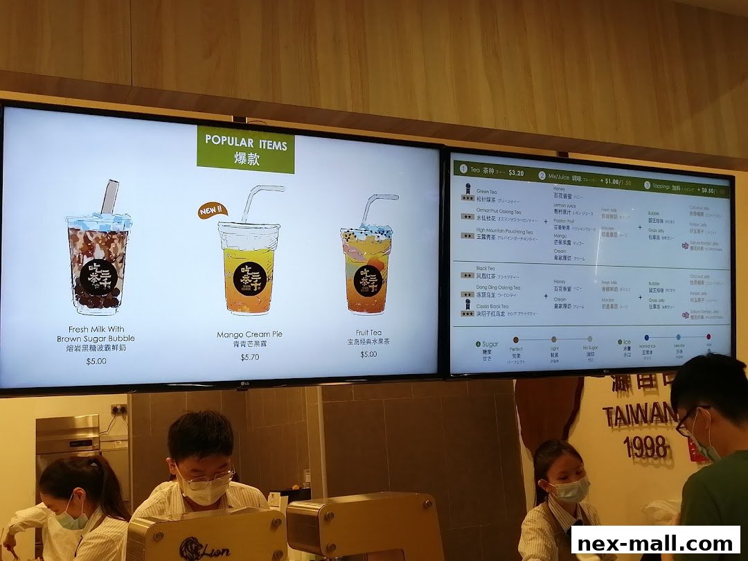 A digital menu board displaying popular bubble tea drinks and customization options.
