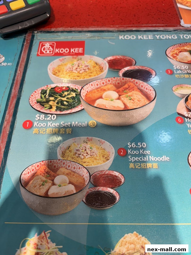 A menu from Koo Kee restaurant showcasing various noodle dishes and set meals.