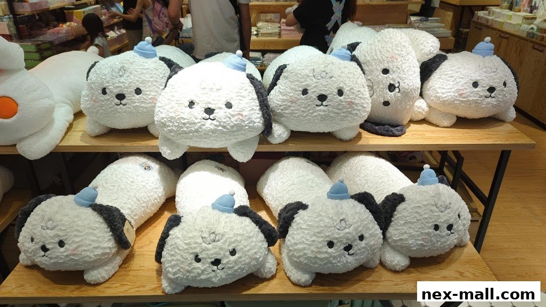A display of fluffy white dog plush toys with blue hats on wooden shelves.