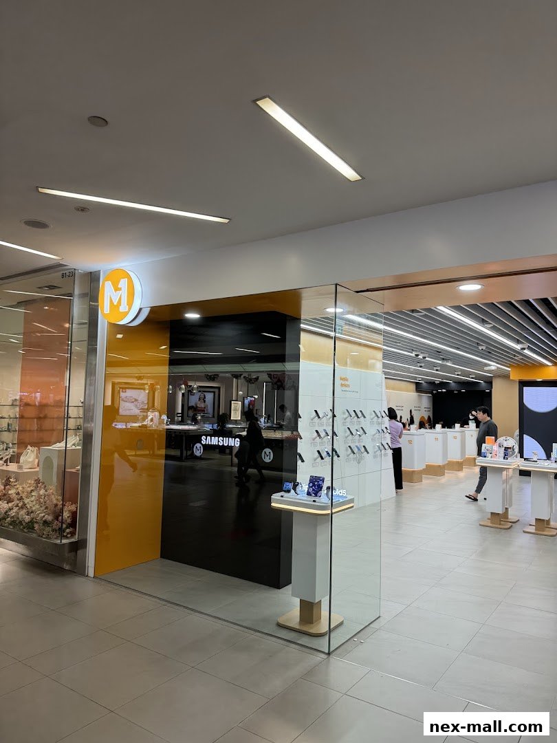 The entrance of a modern phone shop with a prominent 'M' logo and displays of mobile devices.