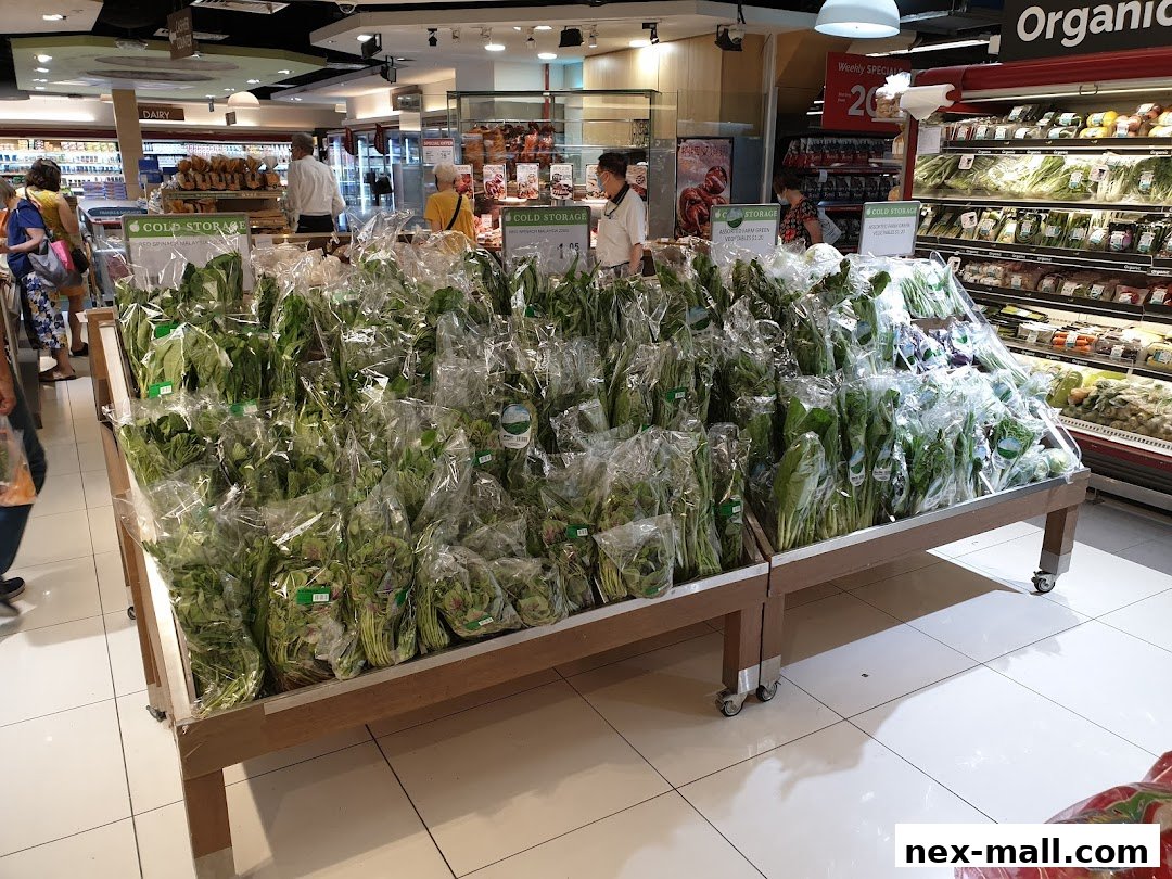 A display of fresh, bagged leafy greens and vegetables at a grocery store.