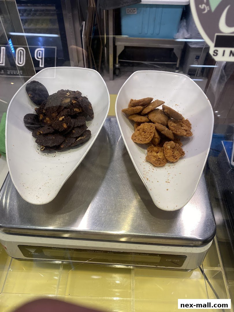 Two white bowls filled with cookies are displayed on a digital scale.