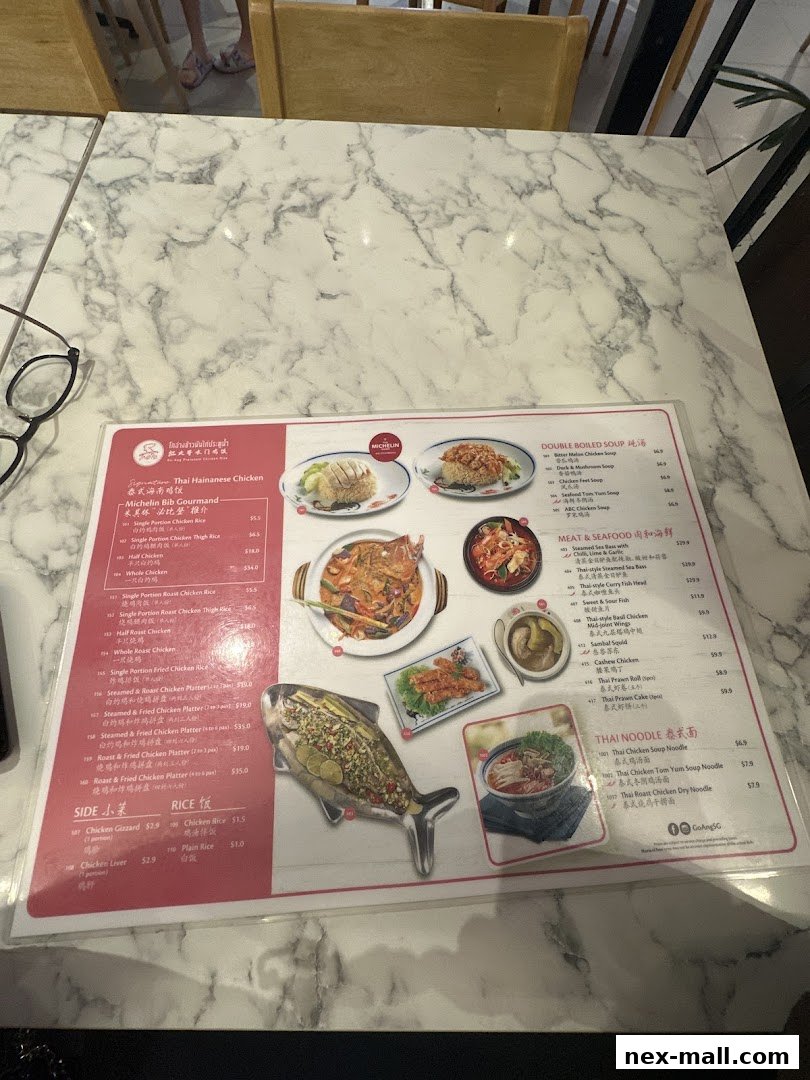 A menu from Go-Ang Pratunam Chicken Rice featuring various chicken dishes, soups, seafood, and noodles.