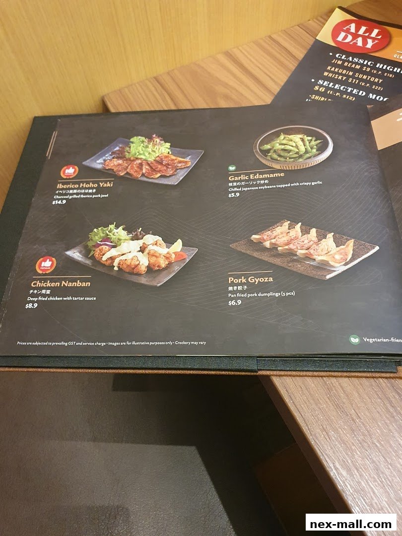A menu from Aburi-EN Nex featuring Japanese dishes like Iberico Hoho Yaki and Pork Gyoza.