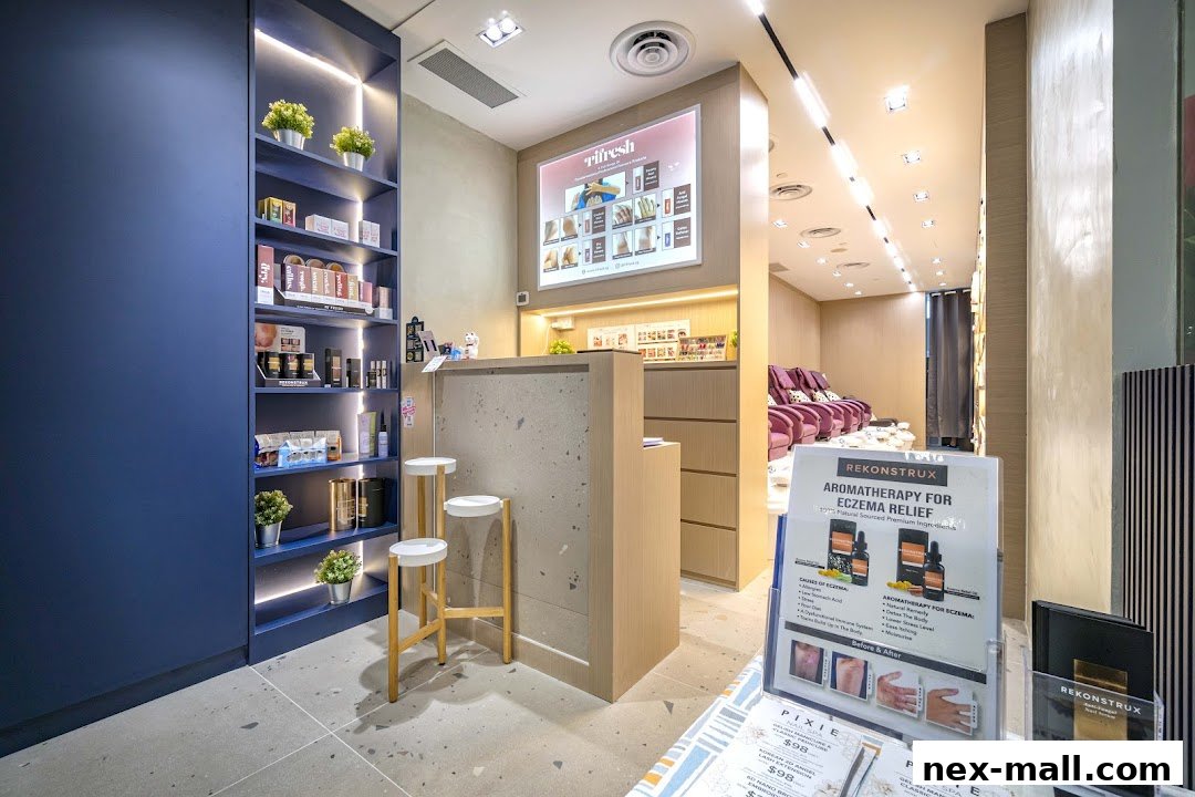 Interior of a modern nail spa with product shelves, a reception desk, and pedicure chairs.