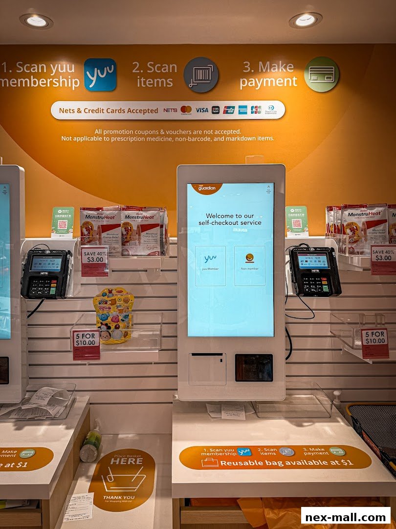 Self-checkout stations at Guardian pharmacy with payment options and product displays.