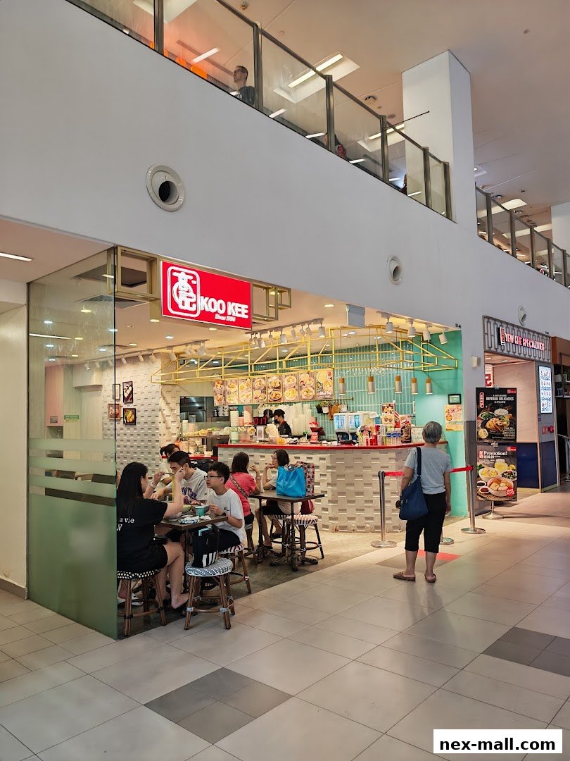 Koo Kee restaurant with customers dining and staff serving at the counter.
