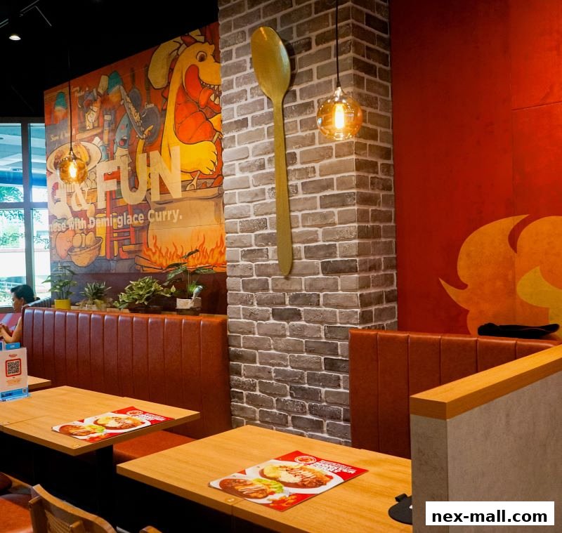 Interior of a restaurant with tables, booths, and a colorful mural.