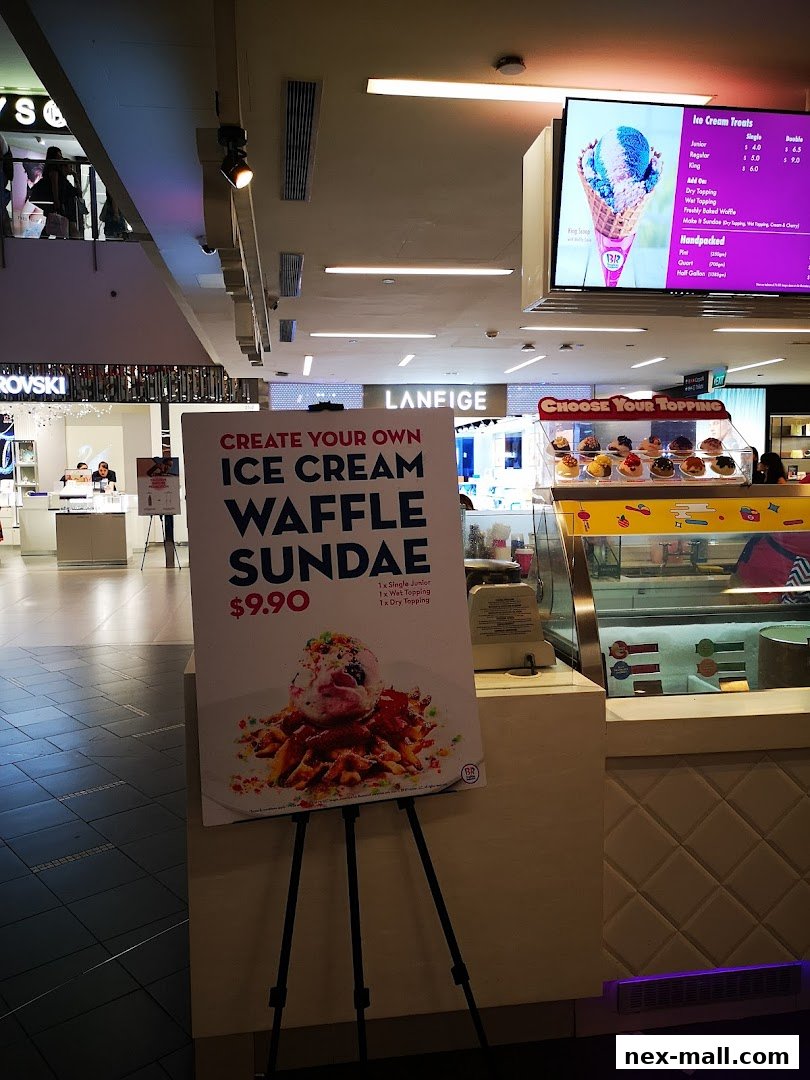 A Baskin-Robbins shop with a sign advertising a custom ice cream waffle sundae.