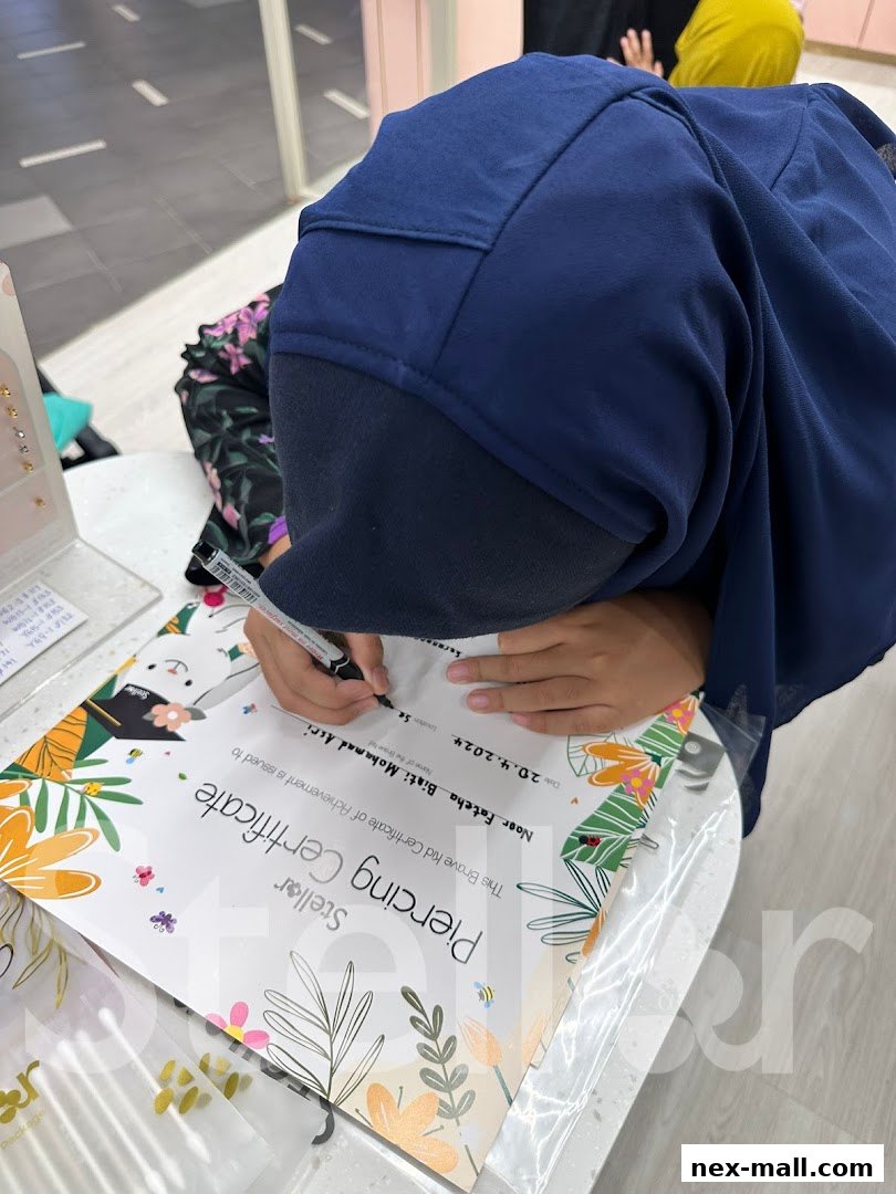 A person receives a 'Piercing Certificate' from Stellar NEX Ear Piercing Jewellery.