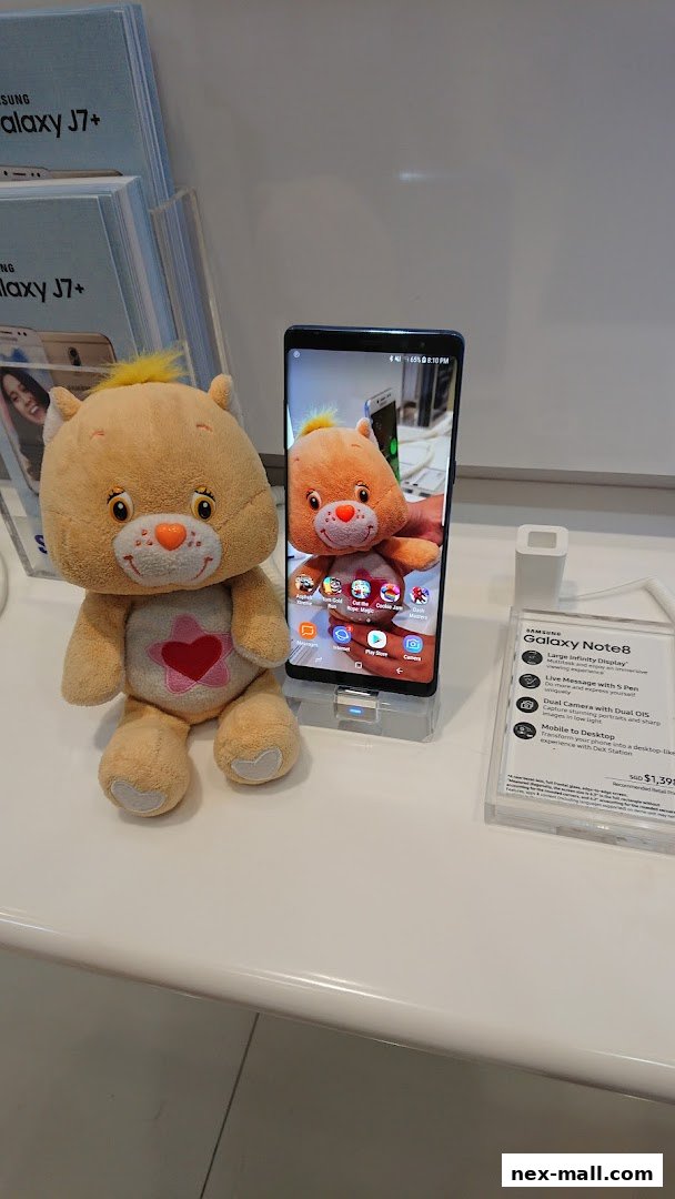 A plush toy sits next to a Samsung Galaxy Note 8 displaying a similar plush toy.