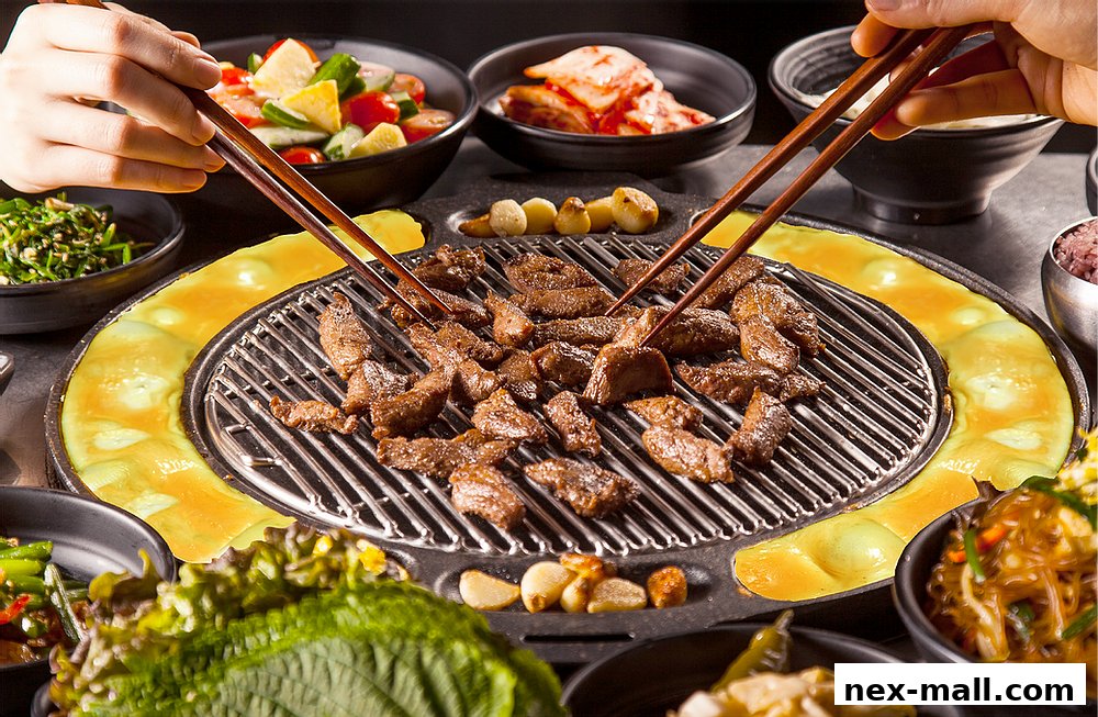 A close-up shot of Korean BBQ with grilled meat, kimchi, salad, and other side dishes.