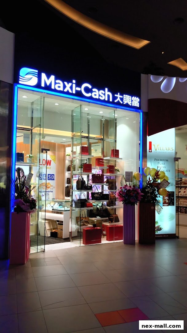 The exterior of a Maxi-Cash store showcasing handbags and jewelry on display.