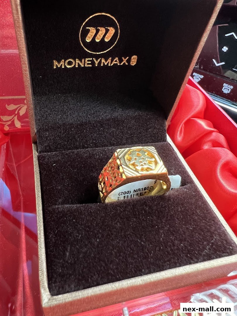 A gold ring with intricate designs is displayed in a MoneyMax jewelry box.