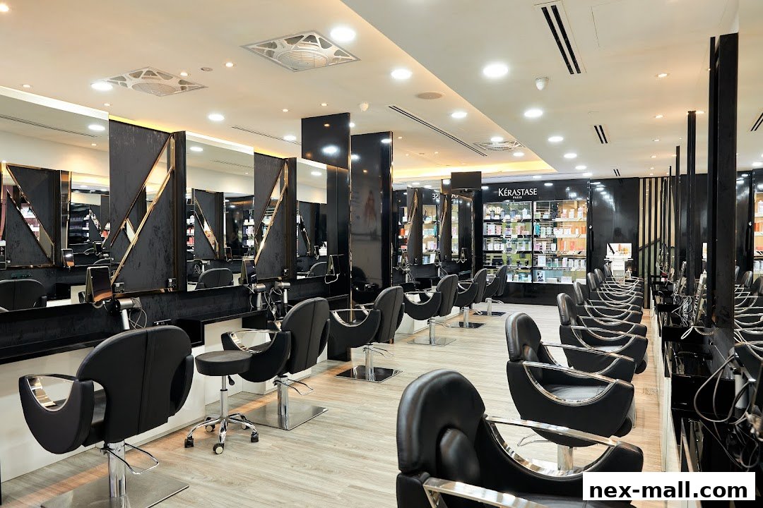 Interior of a modern hair salon with multiple styling stations and Kérastase products on display.