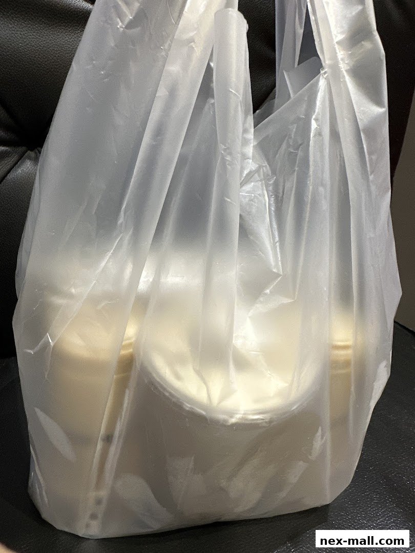 A clear plastic bag filled with several takeaway drinks from KOI Thé.