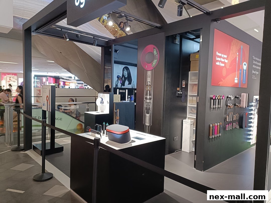 A Dyson shop display featuring hair dryers and other styling tools, with promotional signage.