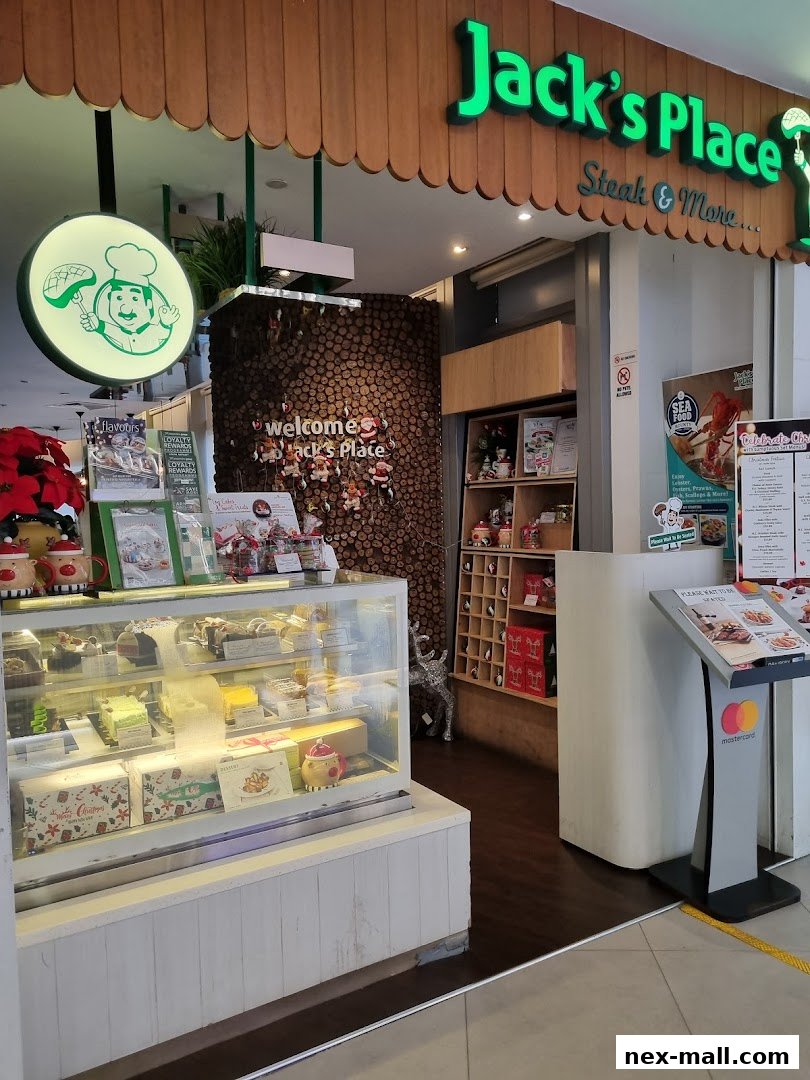 The exterior of Jack's Place NEX, featuring a display of cakes and a welcoming entrance.