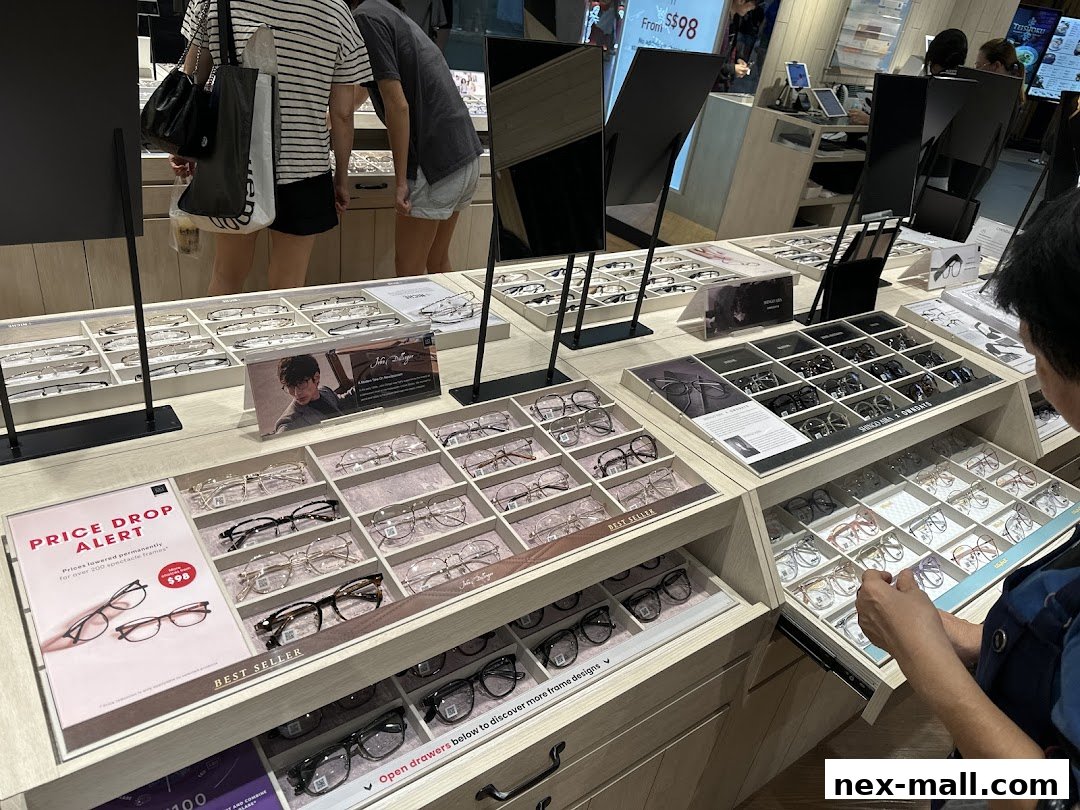 A display of various eyeglasses for sale, with customers browsing.