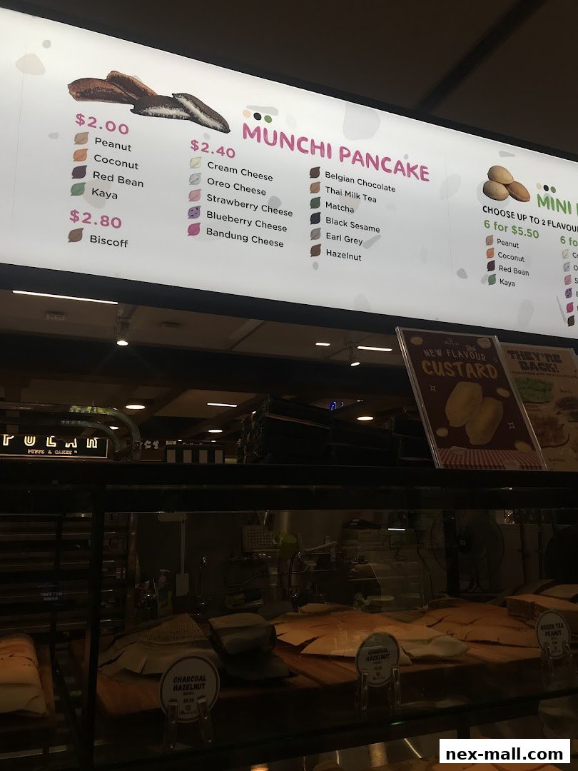 A brightly lit menu board displaying various pancake flavors and prices.