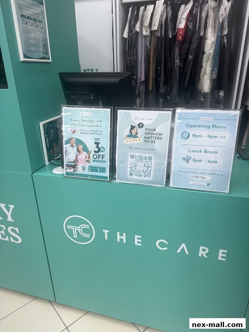 The Care Laundry NEX shop counter with promotional signs and hanging garments.