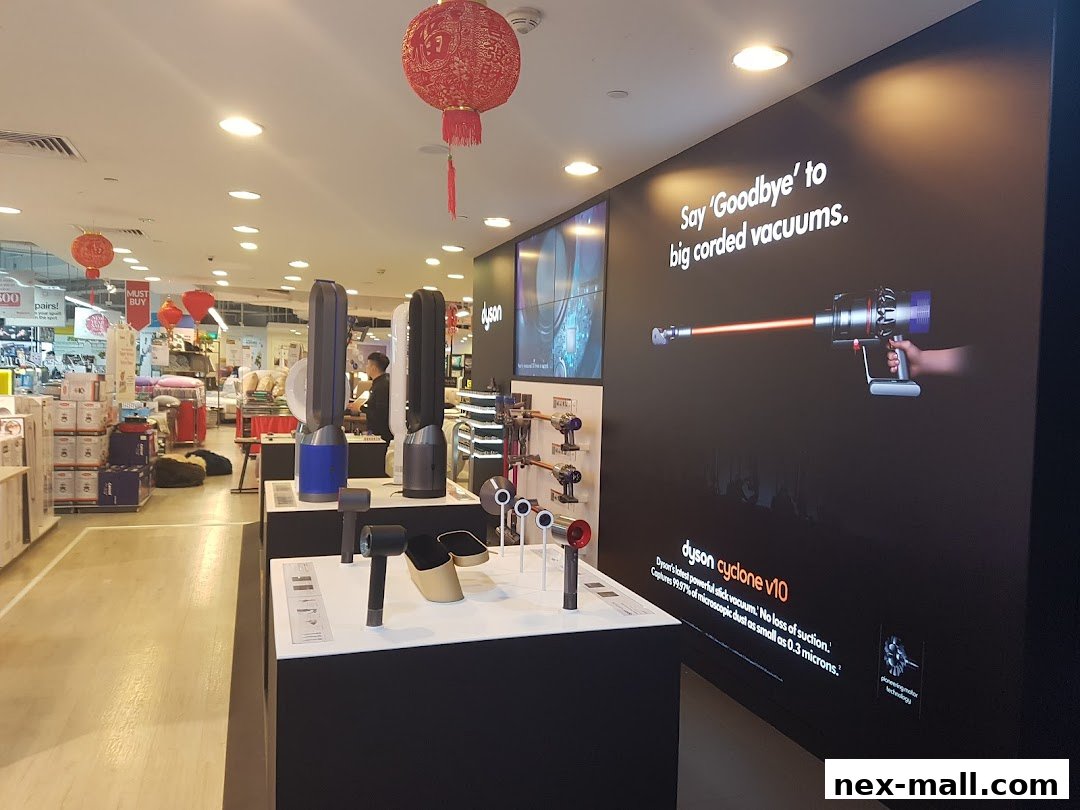 Interior of a COURTS store showcasing Dyson vacuums and fans with promotional signage.