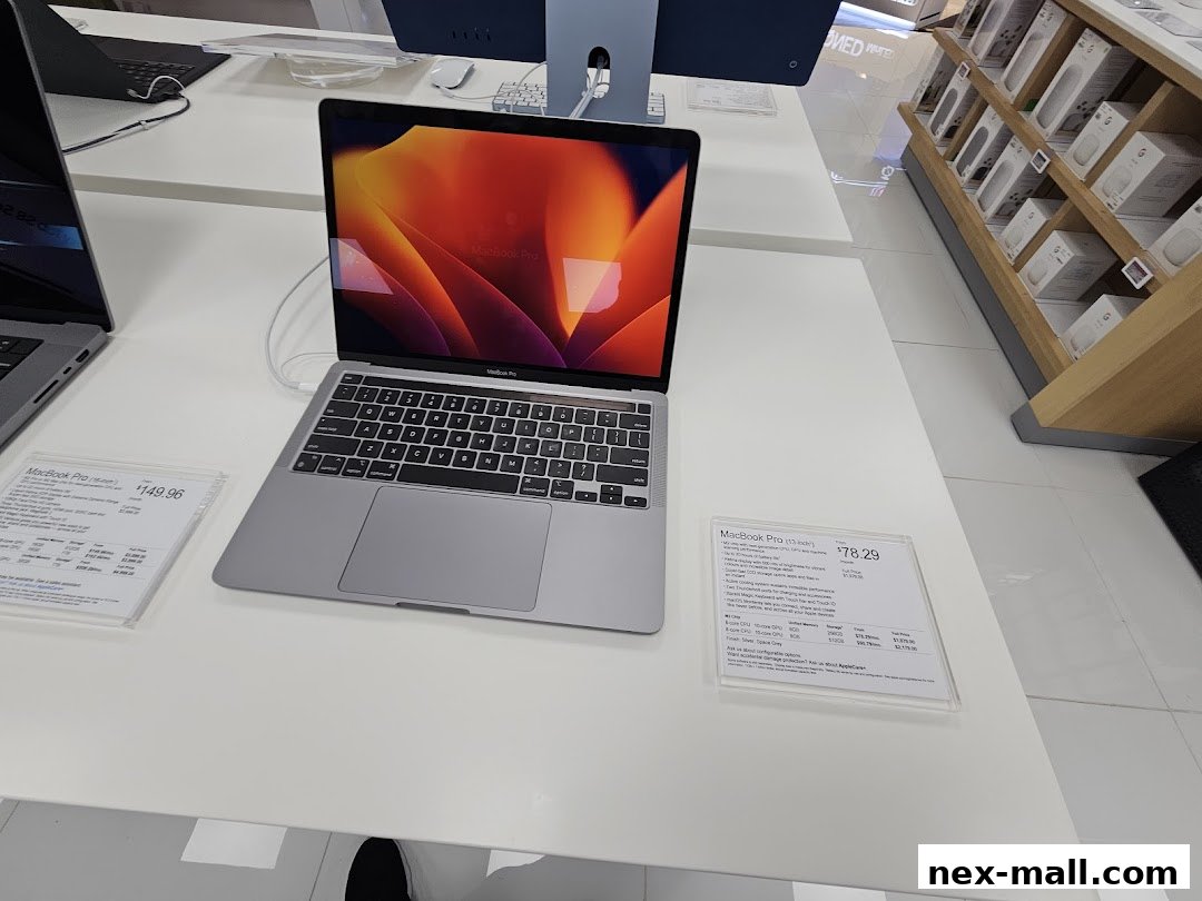 A MacBook Pro laptop is displayed on a white table with product information cards.