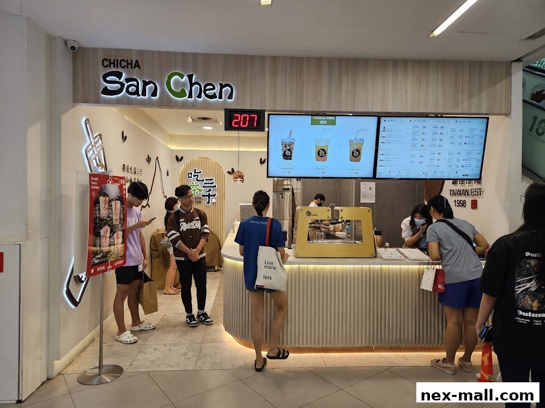 Customers ordering at a CHICHA San Chen bubble tea shop with digital menus.
