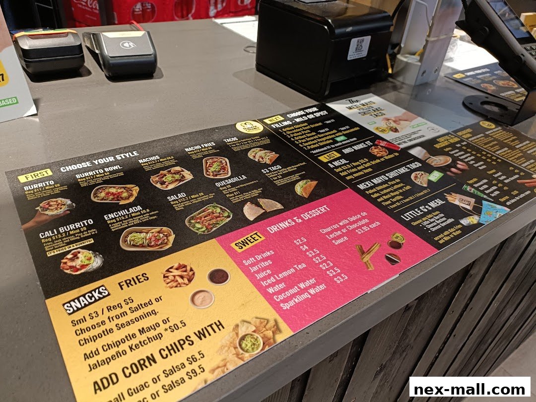 A menu display at a Guzman y Gomez counter showing various Mexican food options and prices.
