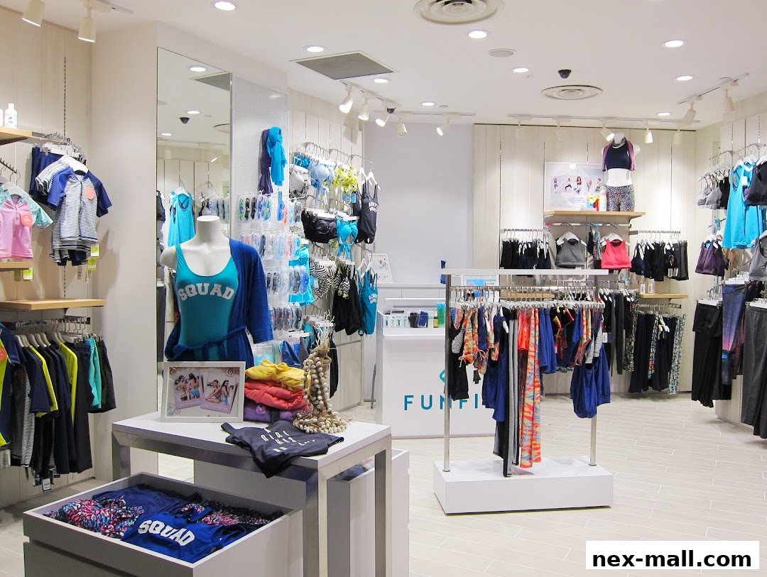 Interior view of a brightly lit clothing store displaying swimwear and activewear.