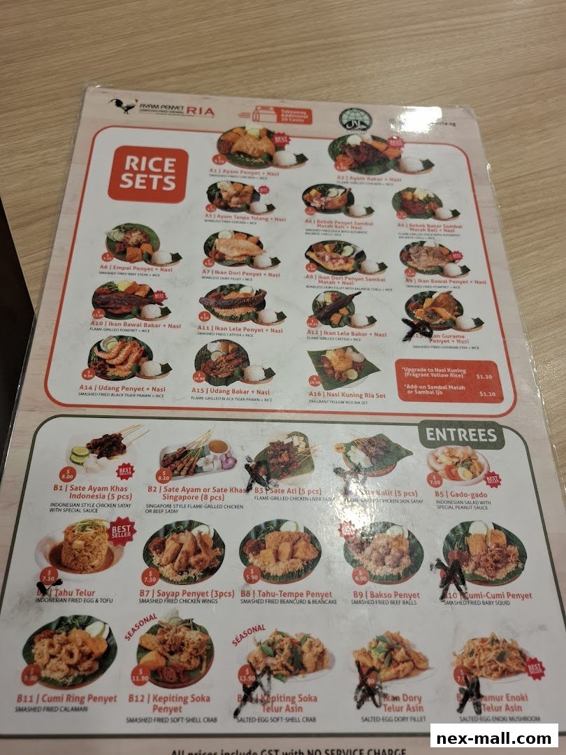 A menu from Ayam Penyet Ria featuring rice sets, satay, and entrees with prices.