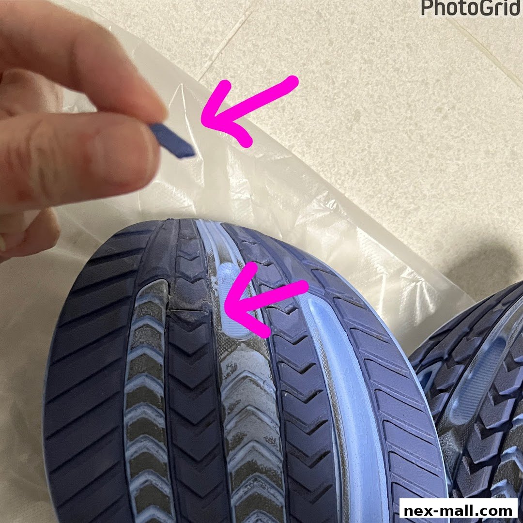 A hand holds a small piece of blue material next to the sole of a blue shoe.