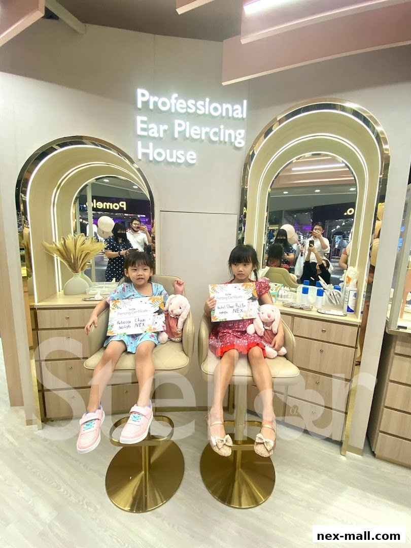 Two young girls proudly display their ear piercing certificates at a professional ear piercing house.