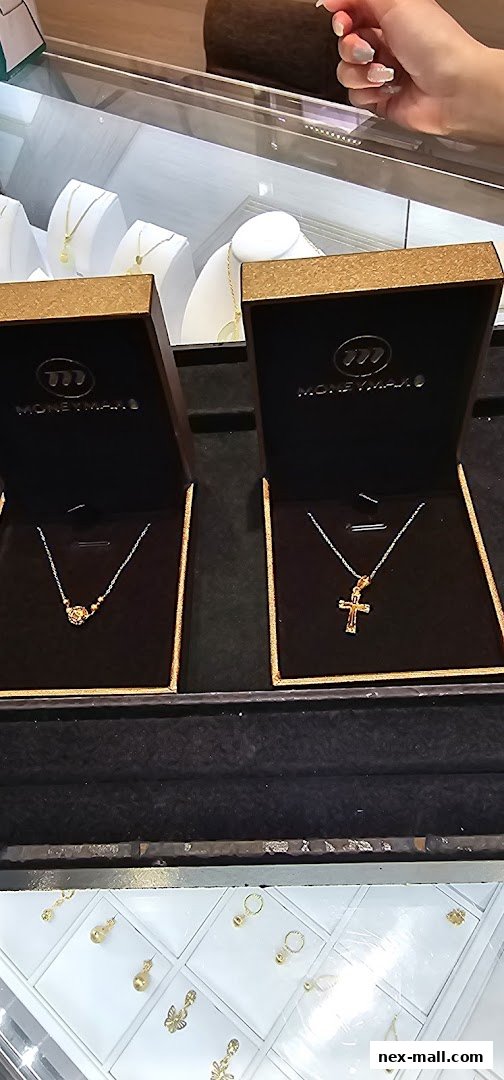 Display of gold necklaces and earrings in a jewelry store showcase.