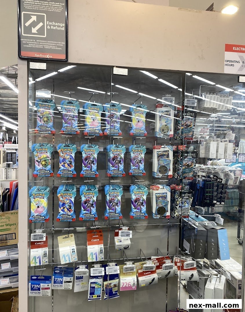 A display of Pokemon trading cards and printer ink cartridges at FairPrice Xtra.