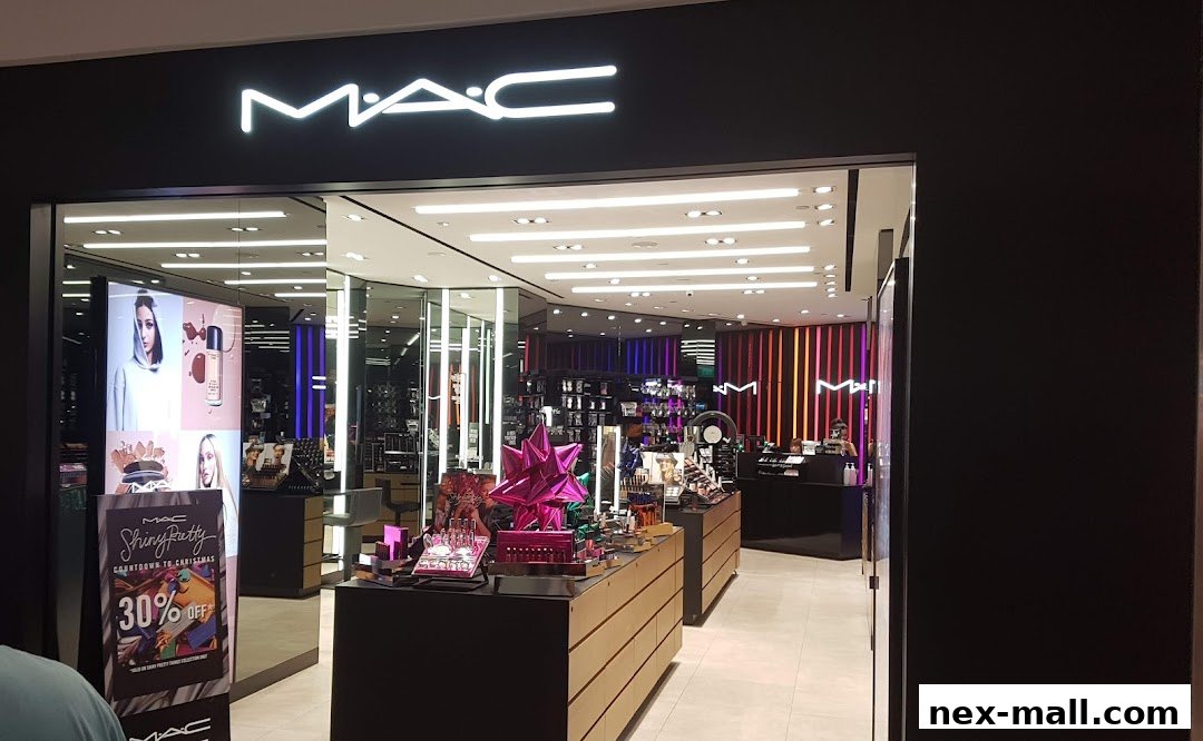 The entrance of a MAC Cosmetics store, showcasing makeup displays and promotional signage.
