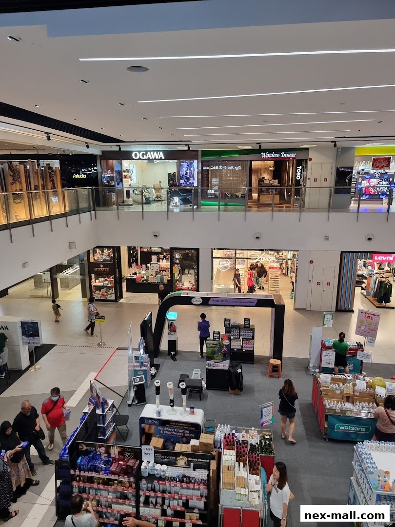 An aerial view of a shopping mall interior with various shops and displays.